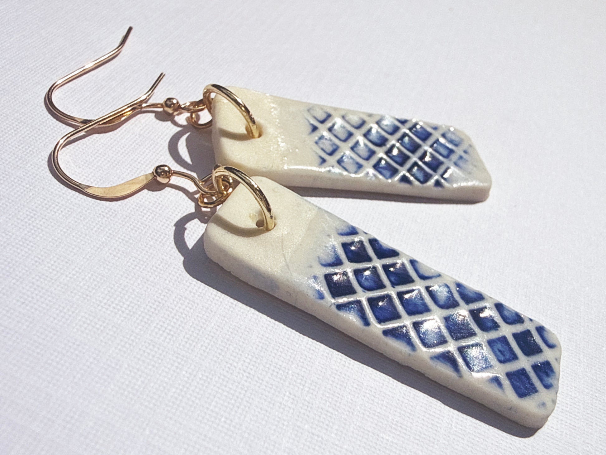 Porcelain rectangle checked earring in cobalt blue on card closeup